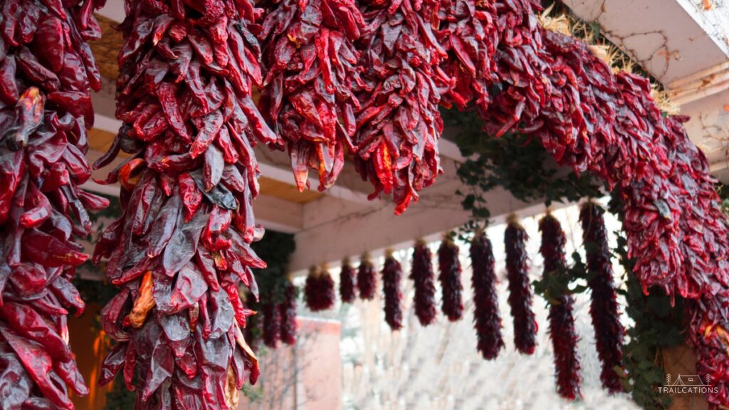 Wind drying hot peppers is a common sight in the American southwest. Long strands of peppers are strung together forming a ristra.