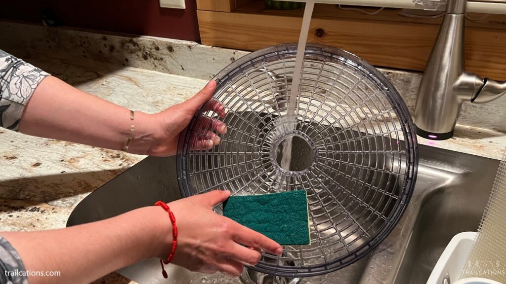 Using a soapy sponge and warm water is an easy way to clean dehydrator trays.